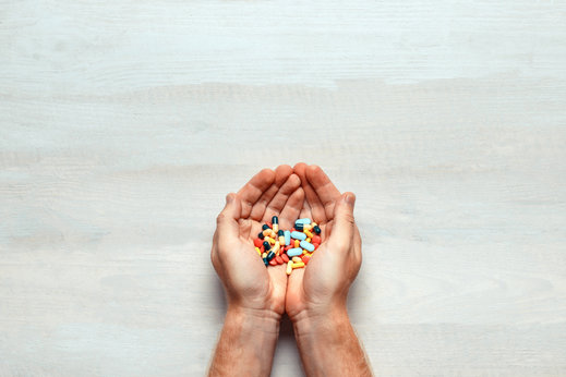 image of a hands with diffirent kinds of medicines