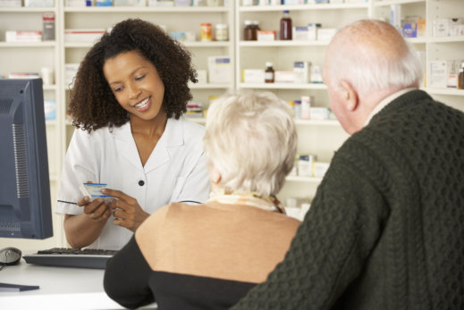 image of pharmacist ecplaining to the senior couple about the medicine